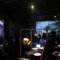 Surround sound: Musicians are scattered throughout the venue and two screens project images throughout a previous performance by the Kansai-based Enso Watt, who draw inspiration from Igor Stravinsky’s “The Rite of Spring.” Musicians, two screens and a poet recapture Stravinsky's spirit in 'Sanka's Winter Ritual'