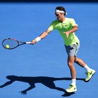 Heading home: Roger Federer plays a shot from Italy's Andreas Seppi in their third-round match at the Australian Open on Friday. Seppi won 6-4, 7-6 (7-5), 4-6, 7-6 (7-5). Seppi stuns Federer in third round
