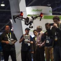 Main attraction: A DJI Inspire 1 drone, manufactured by SZ DJI Technology Co., is flown during the 2015 Consumer Electronics Show in Las Vegas on Jan. 7. Drones take U.S. electronics show by storm