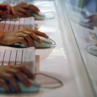 Users browse the Internet in a subway station in Hong Kong. As fraud attempts grow, some firms are testing their workers by sending spoof phishing emails to see who bites. Are you a hack waiting to happen? Firms probe staffers' email gullibility