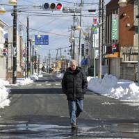CBS News correspondent Bob Simon walks through the town of Tomioka, Fukushima Prefecture, three years after the 2011 Fukushima disaster started in this picture provided by CBS on Wednesday. Simon, whose decades-long career included covering major overseas conflicts and surviving Iraqi prisons, was killed in a car accident Wednesday evening in New York City. He was 73. CBS: '60 Minutes' correspondent Bob Simon, 73, killed in Manhattan car crash