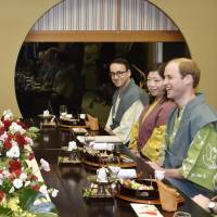 Britain's Prince William and Prime Minister Shinzo Abe enjoy a light-hearted moment as they have dinner at a traditional Japanese inn in Koriyama, Fukushima Prefecture, on Saturday. Britain's Prince William visits Fukushima with Abe