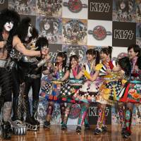 Battle of the bands: Rock group Kiss poses for a photo with idol unit Momoiro Clover Z at a press conference in Tokyo on Saturday. Hotter than hell! Kiss-inspired spicy buns sold ahead of tour
