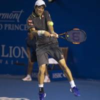 Climbing the ladder: Kei Nishikori plays a shot from Ukraine's Alexandr Dolgopolov in their quarterfinal match at the Mexico Open on Thursday in Acapulco. Nishikori won 6-4, 6-4. Nishikori marches into semifinals