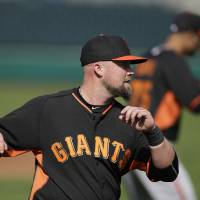 Preparing for the season: Giants third baseman Casey McGehee, seen stretching during spring training on Tuesday in Scottsdale, Arizona, has joined a team not far from where he grew up. AP McGehee at ease after trade to San Francisco