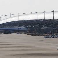 An airplane is seen parked at Kansai International Airport in Izumisano City, Osaka, in January 2011. Sinking under debt, Kansai airport privatization will be test for Abe