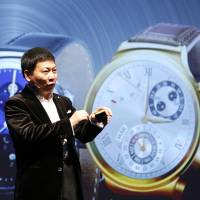 Huawei Chief Executive Richard Yu presents the Huawei Watch during a news conference Sunday in Barcelona, Spain. Chinese telecom equipment maker Huawei on Sunday launched its first smartwatch, a round-faced device that works with Android phones, joining a crowded market weeks before the introduction of the highly anticipated Apple Watch. Phone firms, jewelers hoping 2015 is year of smartwatch