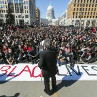 Madison Mayor Paul Soglin addresses a crowd of protestors on Martin Luther King Boulevard Monday in the Wisconsin capital during a protest of the shooting death of Tony Robinson. Madison police officer Matt Kenny shot Robinson on Friday evening while investigating a call that the man was jumping in and out of traffic and had assaulted someone. The officer heard a disturbance and forced his way into an apartment where Robinson had gone. Authorities said Kenny fired after Robinson assaulted him. Court documents: Wisconsin shooting victim was impulsive