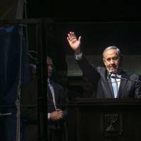 Israeli Prime Minister Benjamin Netanyahu speaks during a rightwing rally Sunday in Tel Aviv's Rabin Square. Israel's center-left opposition is poised for an upset victory in the upcoming parliamentary election, with the last opinion polls before Tuesday's vote giving it a solid lead over Netanyahu's party. Netanyahu makes last shot for rightwing vote at rally