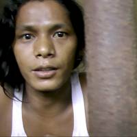 Kyaw Naing, a slave from Myanmar, looks out from a cell at the compound of a fishing company in Benjina, Indonesia, last November in an image made from video. Is the fish you buy caught by slaves?