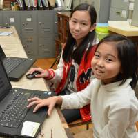 Koto Tomita (left) and her sister, Rino, who discovered a supernova, pose at Ichinomiya High School, where they conduct astronomical research. At 9, girl may be youngest to spot supernova