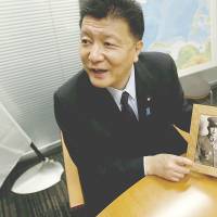 Yoshitaka Shindo, a conservative ruling party lawmaker and grandson of Tadamichi Kuribayashi, commander of the Japanese troops who fought in the Battle of Iwojiima, shows a picture of his grandfather during an interview in Tokyo on March 18. Battle of Iwojima forgotten, except toll