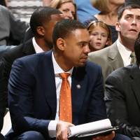 Further education: Utah Jazz assistant Antonio Lang (orange tie) sits on the bench beside head coach Quin Snyder (right) during a game against the Mavericks last November. Former NBL coach Lang enjoying new role with Jazz