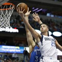 Up to the cup: Dallas' Chandler Parsons goes in for a layup against Oklahoma City in the first half on Monday night. The Mavericks beat the Thunder 119-115. Wall drives Wizards past Blazers, to fourth straight victory