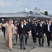 Show of force: Prime Minister Shinzo Abe inspects a mockup F-35A fighter jet on an air base in Omitama, Ibaraki Prefecture, last October. Where will 'proactive pacifism' lead us?