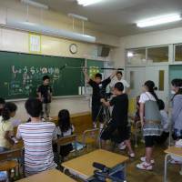 Elementary school students film a video titled “My dream for the future” in September, 2011, as part of the “Kitto Waraeru 2021” program offered by Panasonic Corp. in Kuji, Iwate Prefecture. Major companies continue to support Tohoku region