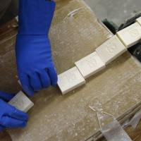 A worker collects newly formed soap at Clean the World in Las Vegas on March 20. The nonprofit initiative joined hands with Global Soap this month to recycle soap from hotels and distribute it in developing countries. U.S. group on mission to save lives with recycled hotel soap