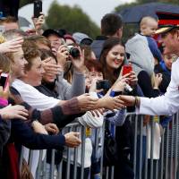 Britain's Prince Harry greets members of the public after visiting the Australian War Memorial in Canberra on Monday. Prince Harry arrives Down Under for month's army stint