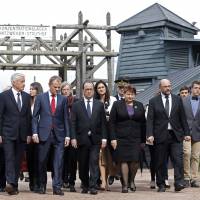 During commemorations Sunday honoring France’s national day of deportations, attendees (from left) Secretary-General of the Council of Europe Thorbjorn Jagland, European Council President Donald Tusk, French President Francois Hollande, Latvian Prime Minister Laimdota Straujuma and European Parliament President Martin Schulz leave the WWII Nazi Natzwiller-Struthof concentration camp in Natzwiller, eastern France. 70 years on since the Nazi camps were liberated, Europe recalls the horrors