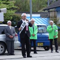 Toshio Tamura, ex-assembly chairman of Kanna, Gunma Prefecture, campaigns Tuesday in the town’s mayoral election. He assumed the post without a vote, as he was the only candidate. Vanishing communities find themselves facing shortage of leaders