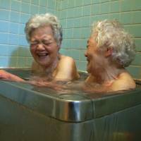 Bath time: Suchie Sakaguchi (left) takes a hot bath with her sister Mariko in her son Katsumi's documentary Walking with My Mother. The film shows Suchie before and after she moves back to the island town where she grew up. Is there life after death for Japan's aging women?