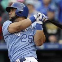 Royal flush: Kansas City designated hitter Kendrys Morales hits a two-run double during the eighth inning on Sunday. Royals rally to defeat Athletics in heated affair