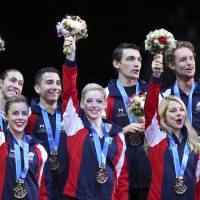 Delighted: Team USA celebrates its World Team Trophy title on Saturday at Yoyogi National Gymnasium. U.S. edges Russia for World Team Trophy title