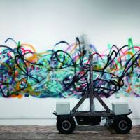 Random graffiti: So Kanno and Takahiro Yamaguchi's senseless drawing bot sprays graffiti along a wall. From dusk till dawn at Roppongi Art Night