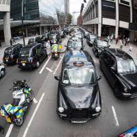Taxi drivers take part in a go slow demonstration in central London on Tuesday against mobile app Uber and regulator Transport for London (TFL) to highlight a report by the Greater London Authority that branded TfL inadequate as an enforcer of the trade. An Italian court the same day ordered the shutdown of the UberPOP app amid protests from cabbies. Court bans UberPOP car service in Italy