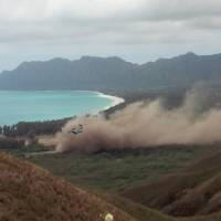 Debris rises as a U.S. Marine Corps Osprey aircraft, not pictured, makes a hard landing at Bellows Air Force Station near Waimanalo, Hawaii, on Sunday. One marine died in the accident and more than a dozen others were taken to a hospital, U.S. media reported. Deadly Osprey crash in Hawaii renews sense of fear in Okinawa