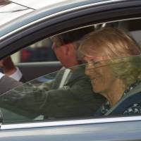 Britain's Prince Charles and wife, Camilla, duchess of Cornwall, leave Kensington Palace on Sunday in London after visiting Prince William and wife Kate following the birth of their daughter. Grandparents come calling on Britain's baby princess as bookmakers bet on her possible name