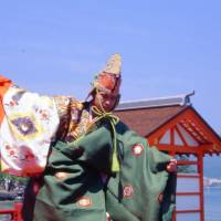 A dancer performs at the shrine. Dancing on the waves at Miyajima