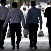 Office workers carry bags containing bento lunch boxes in Tokyo. Salarymen’s allowances have fallen to their lowest level in 33 years while the cost of lunch has surged, according to data released by Shinsei Bank. Salarymen's allowances lowest in three decades as living costs rise