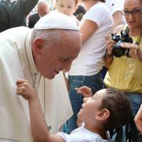 Pope Francis embraces a boy after his meeting with youth on Piazza Vittorio in Turin, Italy, on Sunday. 'Great powers' looked the other way when victims were taken to Auschwitz: pope