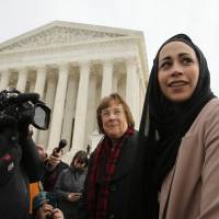 Muslim Samantha Elauf (right), who was denied a sales job at an Abercrombie Kids store in Tulsa, Oklahoma, in 2008, stands with U.S. Equal Employment Opportunity Commission lead attorney Barbara Seely (center) at the U.S. Supreme Court in Washington, on Feb. 25. The court ruled Monday in favor of Elauf. Muslim denied store job over headscarf wins U.S. Supreme Court ruling