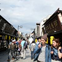 Tourists and locals walk down the main approach to Shibamata Taishakuten Temple in Katsushika Ward, Tokyo, on May 10. Shibamata offers a step back into a Tora-san time warp