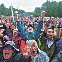Summer songs: Fans cheer at a rainy Fuji Rock Festival at Naeba Ski Resort in Niigata Prefecture. A festival for every weekend of your summer