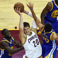 Cavaliers center Timofey Mozgov, center, grabs a rebound during Game 6 of the NBA Finals on June 16 in Cleveland. Cavs pick up Mozgov's 2016 option