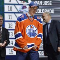 Center Connor McDavid walks off the stage after being selected as the No. 1 overall pick by the Edmonton Oilers in the first round of the NHL Draft on Friday in Sunrise, Florida. McDavid goes No. 1 to Oilers