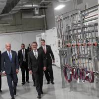Vice President Joe Biden is flanked by Michael Liehr (right), executive vice president of Innovation and Technology, Colleges of Nanoscale Science and Engineering, SUNY Polytechnic Instituteright, and Undersecretary Frank Kendall as he visits SUNY Poly Canal Ponds during the official announcement of the Department of Defense awarding a $110 million to help create the new American Institute for Manufacturing Integrated Photonics Monday in Rochester, New York. Also attending the event is New York Governor Andrew Cuomo (back right). Rochester bags $600 million hub for photonics R&D