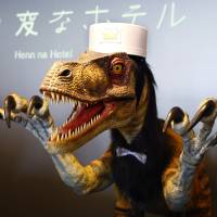 A receptionist dinosaur robot performs at a new hotel, aptly called Henn na Hotel, or Weird Hotel, in Sasebo, Nagasaki Prefecture, on Wednesday. Robot porter, check-in staff at innovative Sasebo hotel