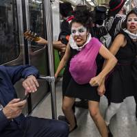 Clowns from the group Ponte la del Metro perform inside a metro car in Mexico City on March 31. Clowns, masked hero use humor in bid to make Mexico City safer for pedestrians, subway riders