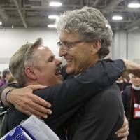 The Rev. Michael Briggs, left, and the Rev. Ken Malcolm, right, hug after Episcopalians overwhelmingly voted Wednesday in Salt Lake City to allow religious weddings for same-sex couples. The vote came in Salt Lake City at the Episcopal General Convention, just days after the U.S. Supreme Court legalized gay marriage nationwide. Vote paves way for same-sex marriages in Episcopalian churches
