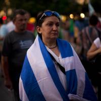 Demonstrators gather near the Greek Parliament in protest at the government's agreement with creditors in Athens on Tuesday. IMF believes Greece needs debt relief far beyond EU plans