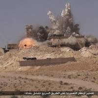 Smoke and fire burst from a Syrian military position being attacked by Islamic State militants on a highway between Damascus and Baghdad in this photo released on June 18. The group’s focus on results contrasts with the inefficient rigidity of the Iraqi and Syrian militaries, where officers often fear taking action without direct approval from higher up. Shock troops who fight to the death key to Islamic State success