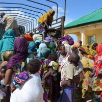 Some of the 59 individuals rescued from Boko Haram camps in Maiduguri, Borno State, in northeastern Nigeria, climb onto a truck Thursday. Nigeria's army said it had set free 59 people held by Boko Haram, among them 29 women and 25 children, amid an ongoing offensive against the Islamist group in the country's restive northeast. Nigeria forces free 59 women, children held by Boko Haram