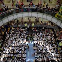 A mass wedding takes place inside a shopping center in Manila on June 21. With their functions expanding from shopping and dining to venues for Catholic Mass, Zumba workouts and weddings, experts say malls are taking on a more important role at the heart of communities. Eat, pray, shop: Philippine malls become the new town plazas