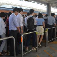 The joys of travel: Morning commuters change trains in Shinjuku. Don't get derailed when you're angry