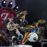 Fuji rocked: Dave Grohl performs from a throne made of guitars on Friday night at the Fuji Rock Festival. The musician broke his leg while performing earlier this summer. Never mind the lineup: Fuji Rock is more than music