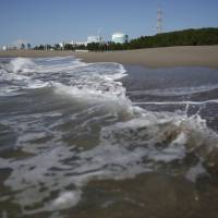 Kyushu Electric Power Co.’s Sendai nuclear power station is seen from the shore in Satsumasendai, Kagoshima Prefecture, last Saturday, three days before its No. 1 reactor was restarted on Tuesday. Nuclear power plant restarts part of wider plan to meet 2030 'best energy mix'
